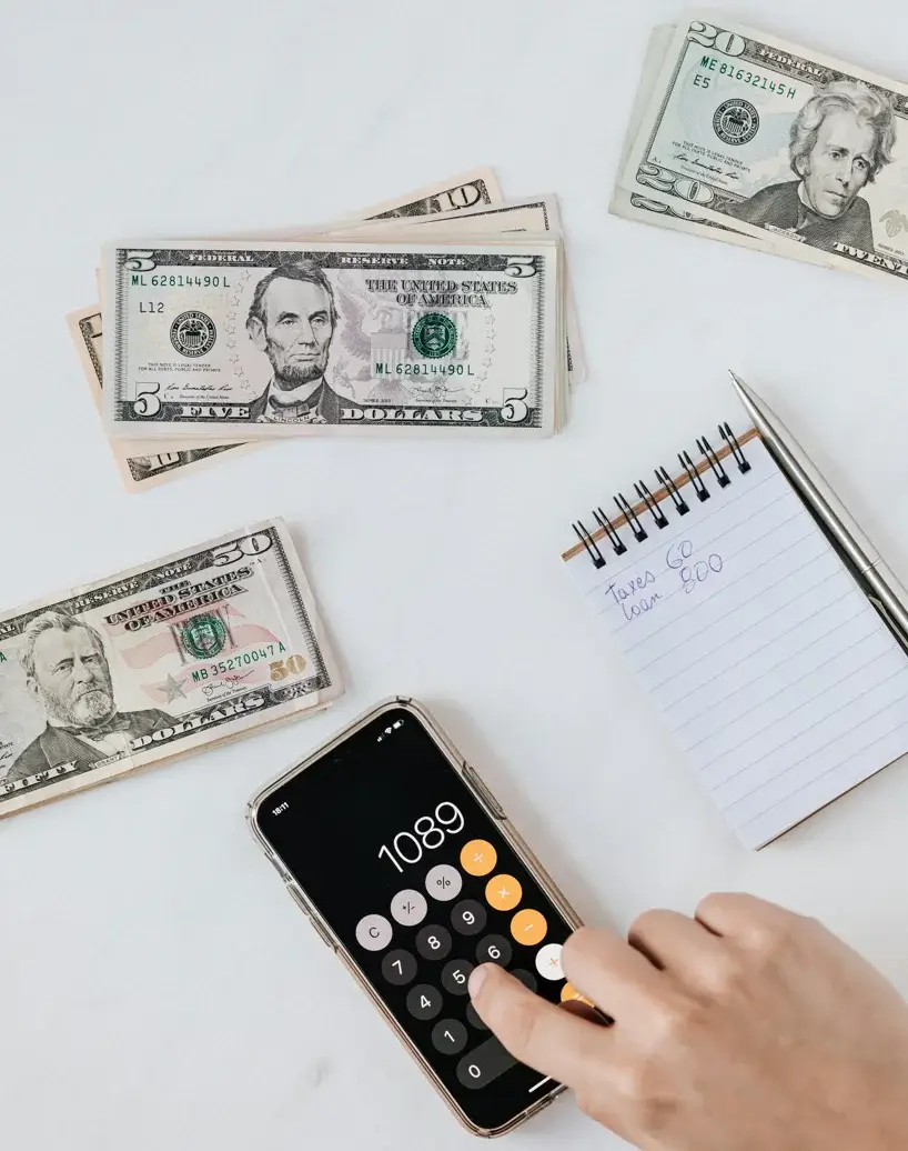 Cash, calculator and written figures used in a secured-financing review